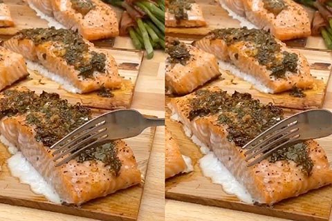 Cedar planked salmon filets topped with garlic & herb sauce fueled by James Brown